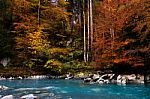 Blue River With Autumn Colors On The Trees Stock Photo
