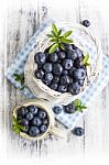 Blueberry Basket And Jug On White Wooden Table Stock Photo