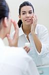 Body Care. Woman Applying Cream On Face Stock Photo
