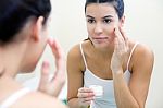 Body Care. Woman Applying Cream On Face Stock Photo