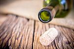 Bottle Of Wine With Corks On Old Wooden Stock Photo