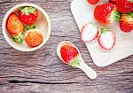 Bowl With Fresh Strawberries On An Old Wooden Table Stock Photo