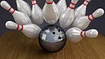 Bowling Ball And Pins On Moment Of Strike Impact Stock Photo