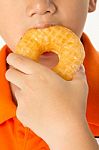 Boy Eating A Donut Stock Photo