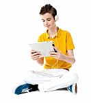 Boy Listening Music With Tablet Pc Stock Photo