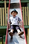 Boy On A Slide Having Fun Stock Photo