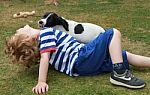 Boy Playing With Spaniel Puppy Stock Photo