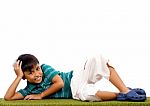 Boy Relaxing On Grass Stock Photo