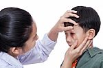 Boy With An Injured Eye. Doctor Examining And First Aid A Patient Injured On Left Eye Bruise Stock Photo