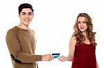 Boyfriend Handing Over The Credit Card To His Girl Stock Photo