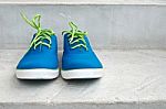 Brand New Blue Sneaker On Cement Floor Stock Photo
