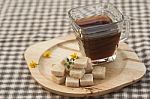 Brown Sugar Cube And Black Coffee On Wooden Plate Stock Photo