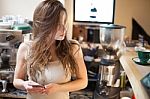 Brunette In Kitchen With Mobile Phone Stock Photo