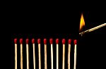 Burning Match With Row Of Matches Isolated On Black Background Stock Photo