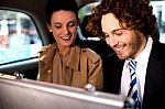 Business Colleagues Travelling Together In Taxi Cab Stock Photo