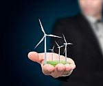 Business Hand With Wind Turbines Stock Photo
