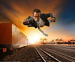Business Man Flying Against Logistic Industry Background Stock Photo