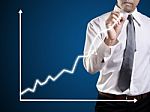 Business Man Hand Drawing A Graph Stock Photo