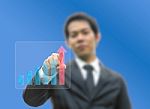 Business Man Pointing Growing Graph Stock Photo