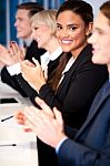 Business Team Of Four Applauding Stock Photo