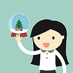 Business Woman Is Holding Snow Globe With A Christmas Tree Inside Stock Photo
