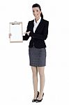 Business Woman Pointing At The Clipboard Stock Photo