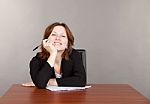 Business Woman Sitting At The Table Stock Photo