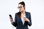 Business Woman Using Her Mobile Phone And Drinking Coffee Stock Photo