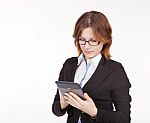 Business Woman With Glasses Looking At The Tablet Display Stock Photo
