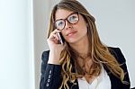 Business Young Woman Using Her Mobile Phone In The Office Stock Photo