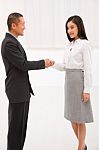 Businessman And Businesswoman Shaking Hands Stock Photo