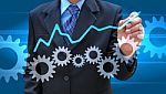 Businessman Hand Drawing Business Graph And Cog Gear Stock Photo