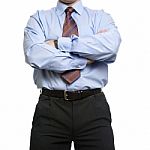 Businessman In Blue Shirt Stands With Crossed Folded Hands Stock Photo