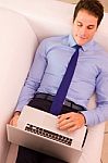 Businessman Lying Couch Using Laptop Stock Photo