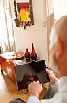 Businessman Middle-aged Working From Home With A Tablet Stock Photo