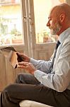 Businessman Middle-aged Working From Home With A Tablet Stock Photo