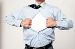 Businessman Pulling His T-shirt Open Stock Photo