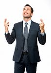 Businessman Smiling Fingers Crossed Stock Photo