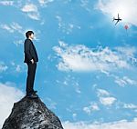 Businessman Standing On Rock Stock Photo