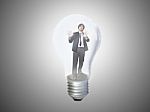 Businessman Trapped In Lightbulb Stock Photo