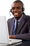 Businessman With Headset And Laptop Stock Photo
