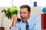 Businessman Yelling During The Phone Call Stock Photo