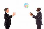 Businessmen Playing With Globe Stock Photo