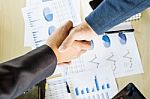 Businessmen Shaking Hands During A Meeting Stock Photo