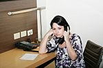 Businesswoman Having Boring Call In Office Stock Photo