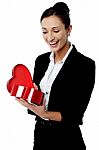 Businesswoman Looking At Her Valentine Gift Stock Photo