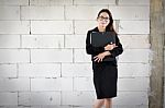 Businesswoman Standing Holding A File  In A Brick Building Stock Photo