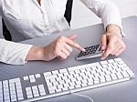 Businesswoman Using Calculator Stock Photo