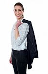 Businesswoman With Coat Slung Over Her Shoulder Stock Photo