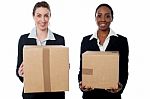 Businesswomen Holding Packed Cartons Stock Photo